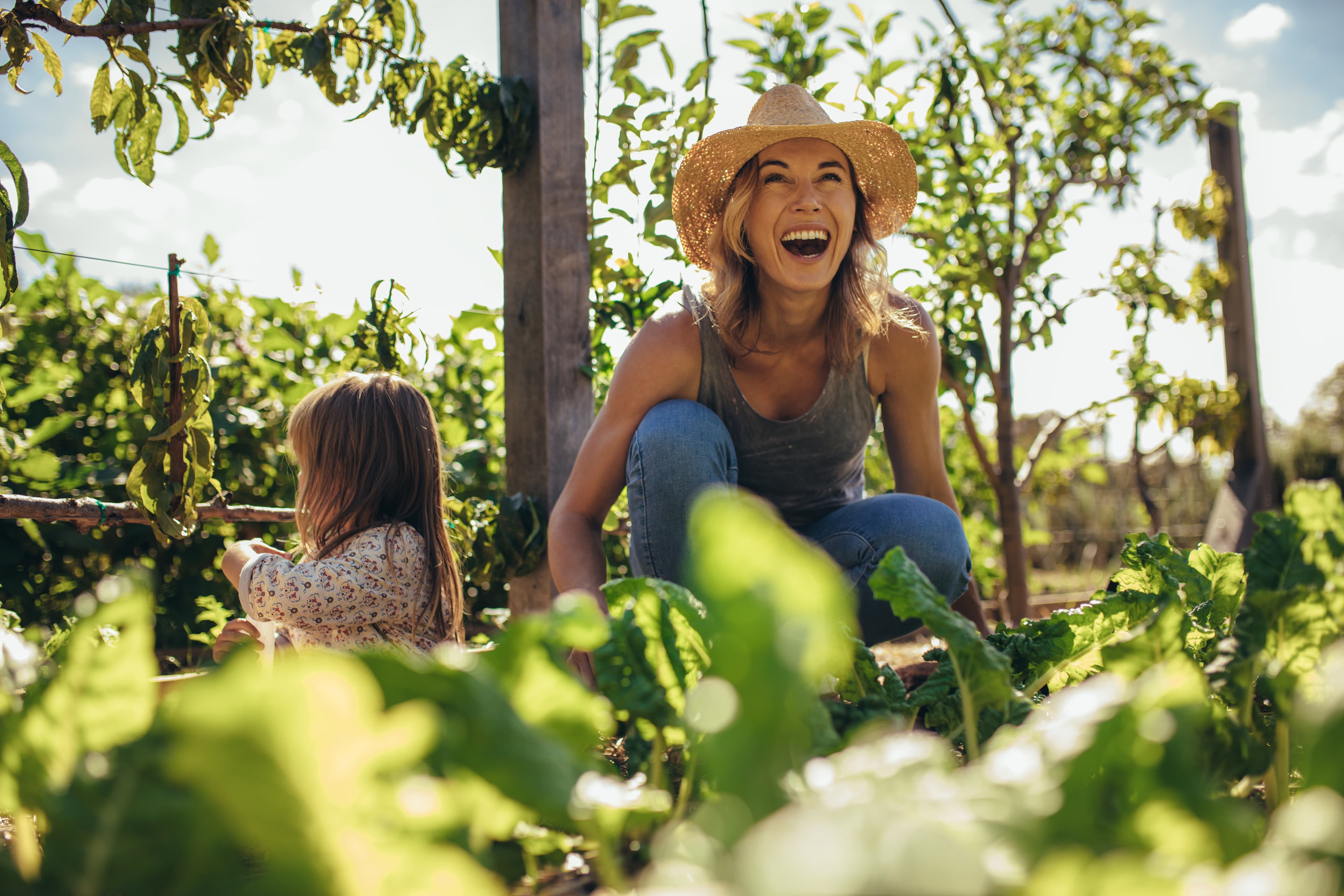 happy women farming with child