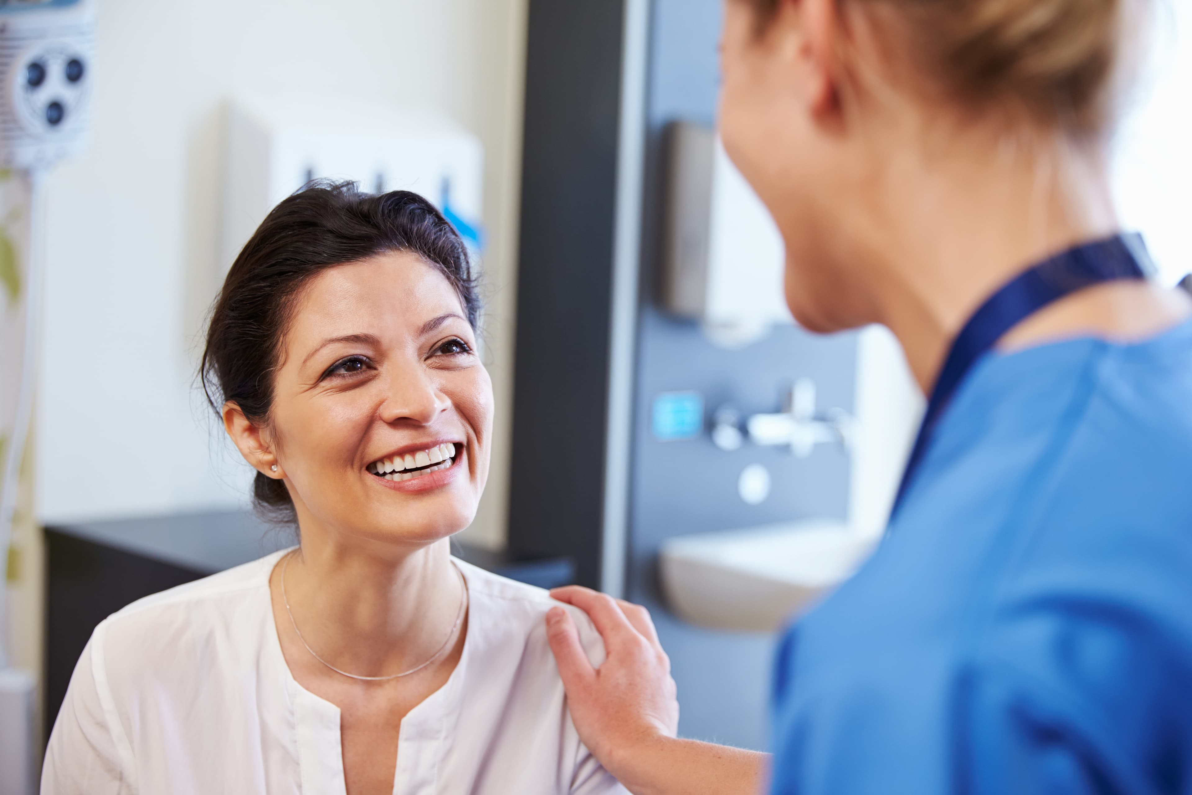 doctor talking with a smiling patient
